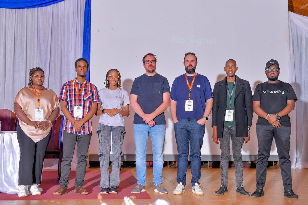 The volunteer crew behind AgentCon Mukono on stage