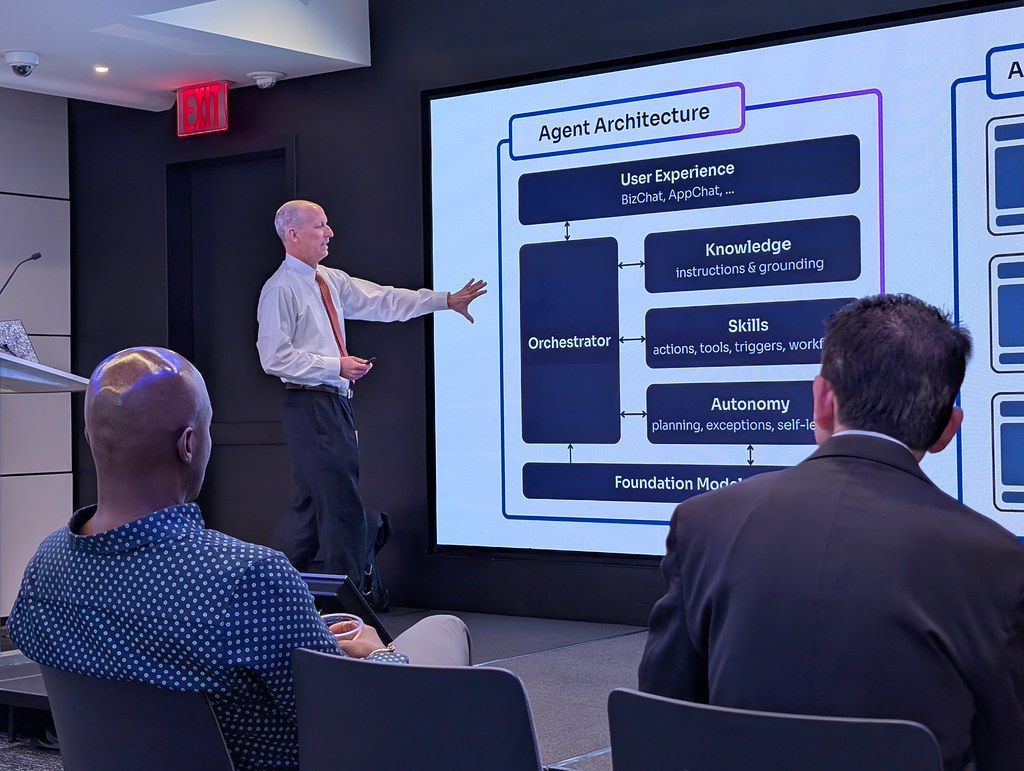 A speaker walking through an agent architecture at AgentCon New York